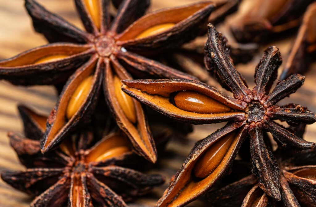 pexels photo 34927370 34927370 Detailed macro image of star anise spices on a natural wooden background, highlighting textures.