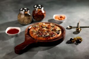 pexels photo 36925856 36925856 1 Tantalizing homemade pizza with olives, spices, and sauce, perfect for a cozy meal.