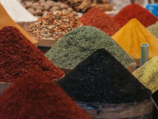 Common Spice Adulteration in India: What Every Household Should Know Colorful variety of spices in a bustling market setting, featuring vibrant powders and aromatic herbs.