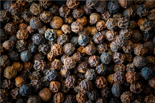 The Ultimate Indian Masala Dabba Guide: 7 Essential Spices Every Kitchen Should Have Rich texture and detail of whole black peppercorns in a macro shot.